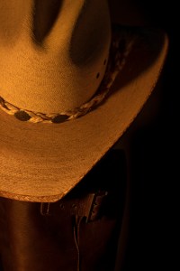 Still life photograph of cowboy hat and boots