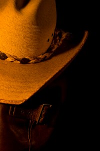 Still life photograph of cowboy hat and boots