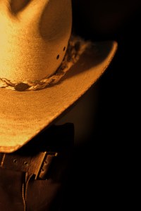 Still life photograph of cowboy hat and boots