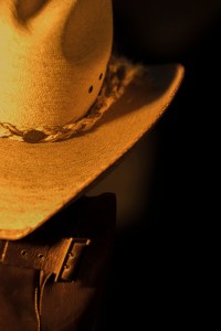 Still life photograph of cowboy hat and boots