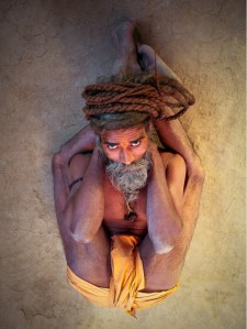 Colour photograph taken from above of yogi in sleeping pose